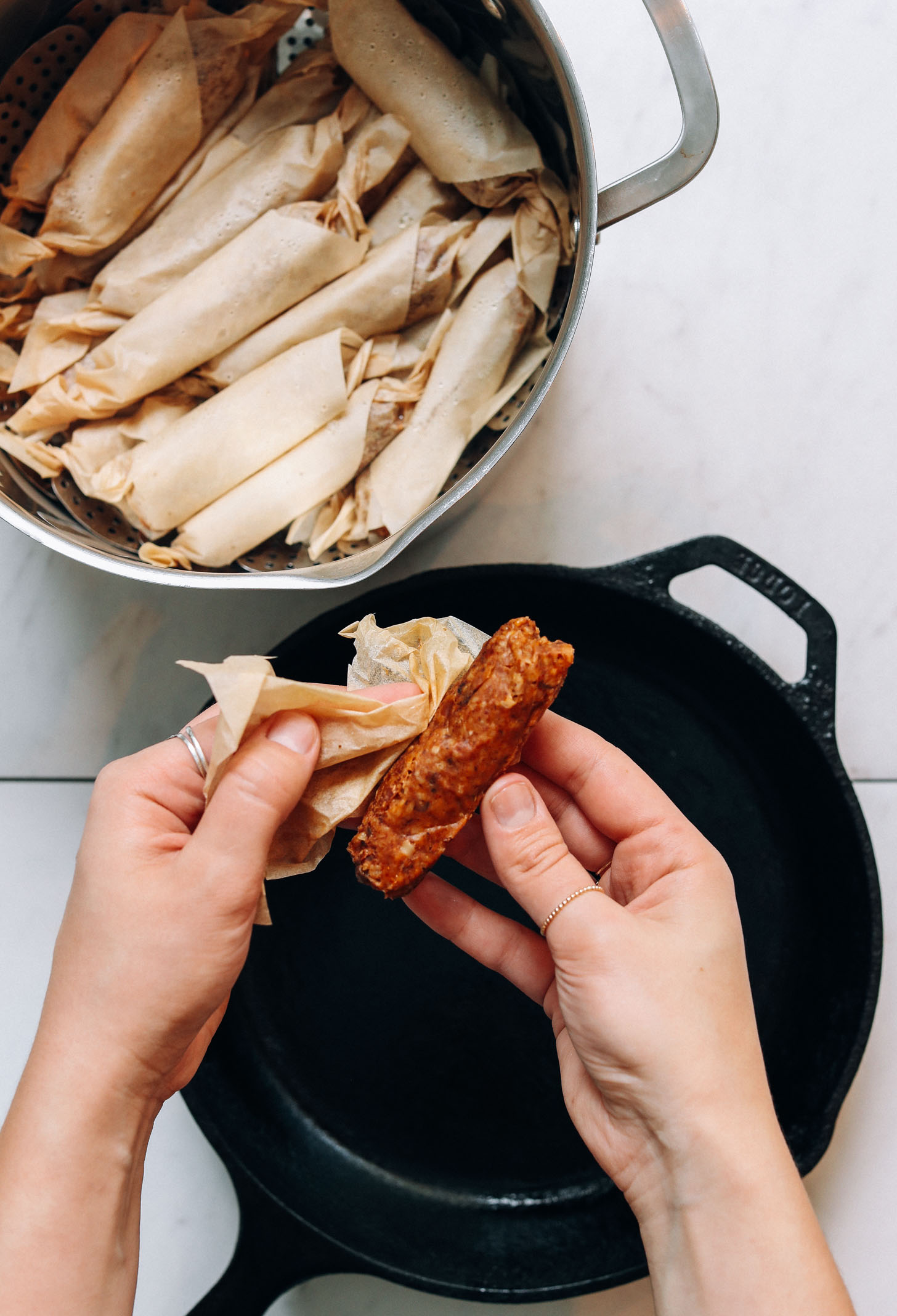 Unwrapping a vegan sausage link from a piece of parchment paper