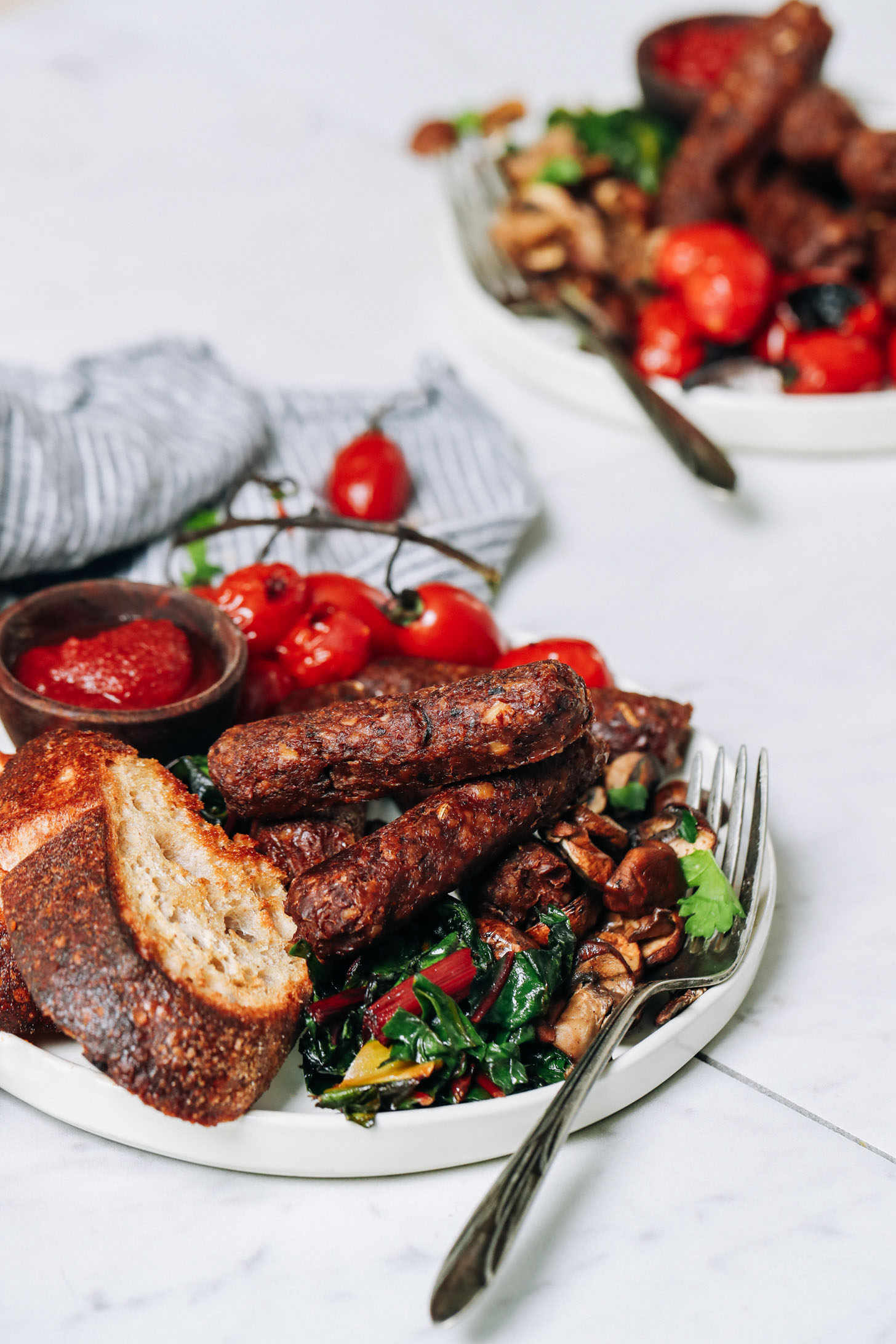 Plate of vegan breakfast sausages with toast and vegetables
