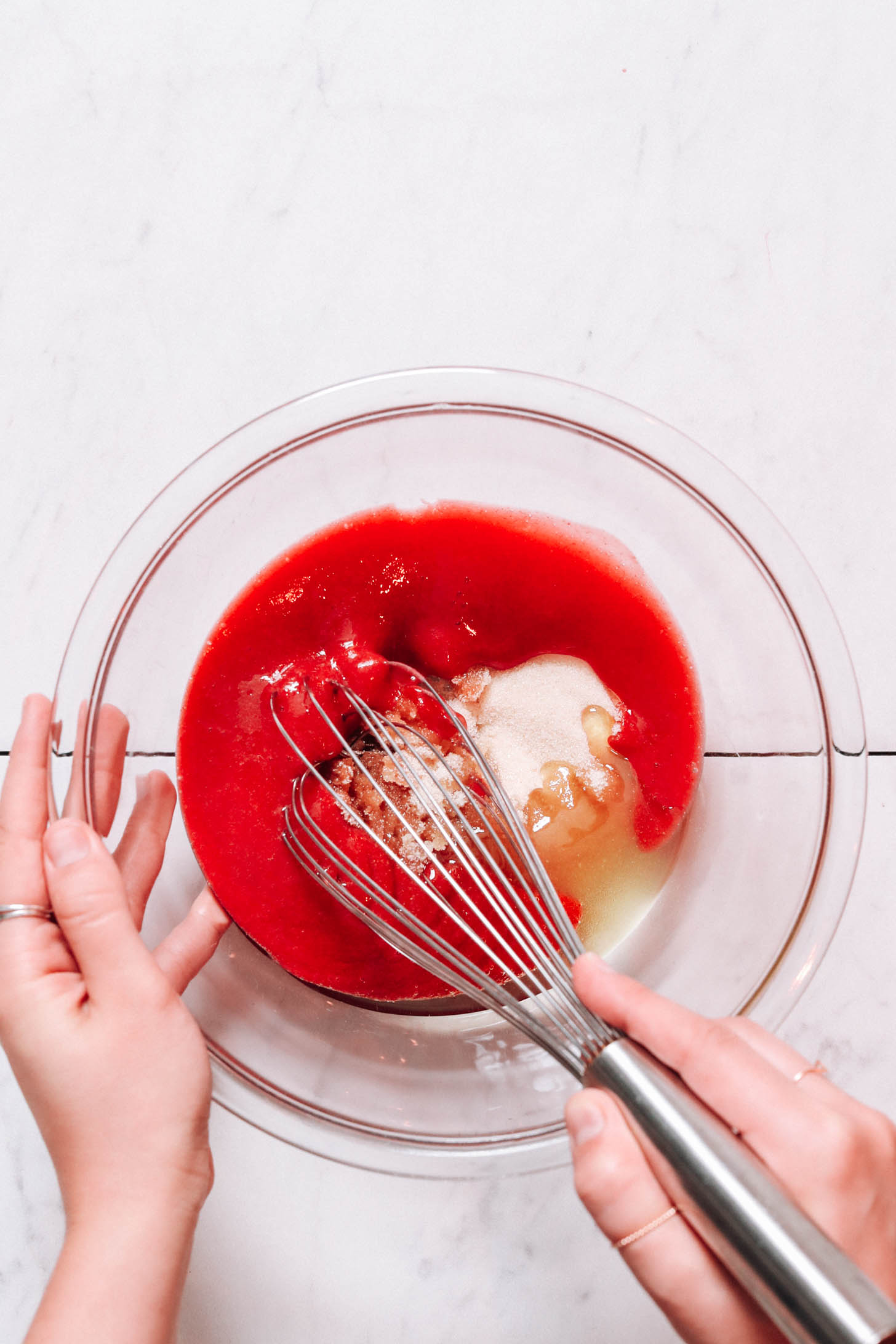 Whisking strawberry purée with other wet ingredients
