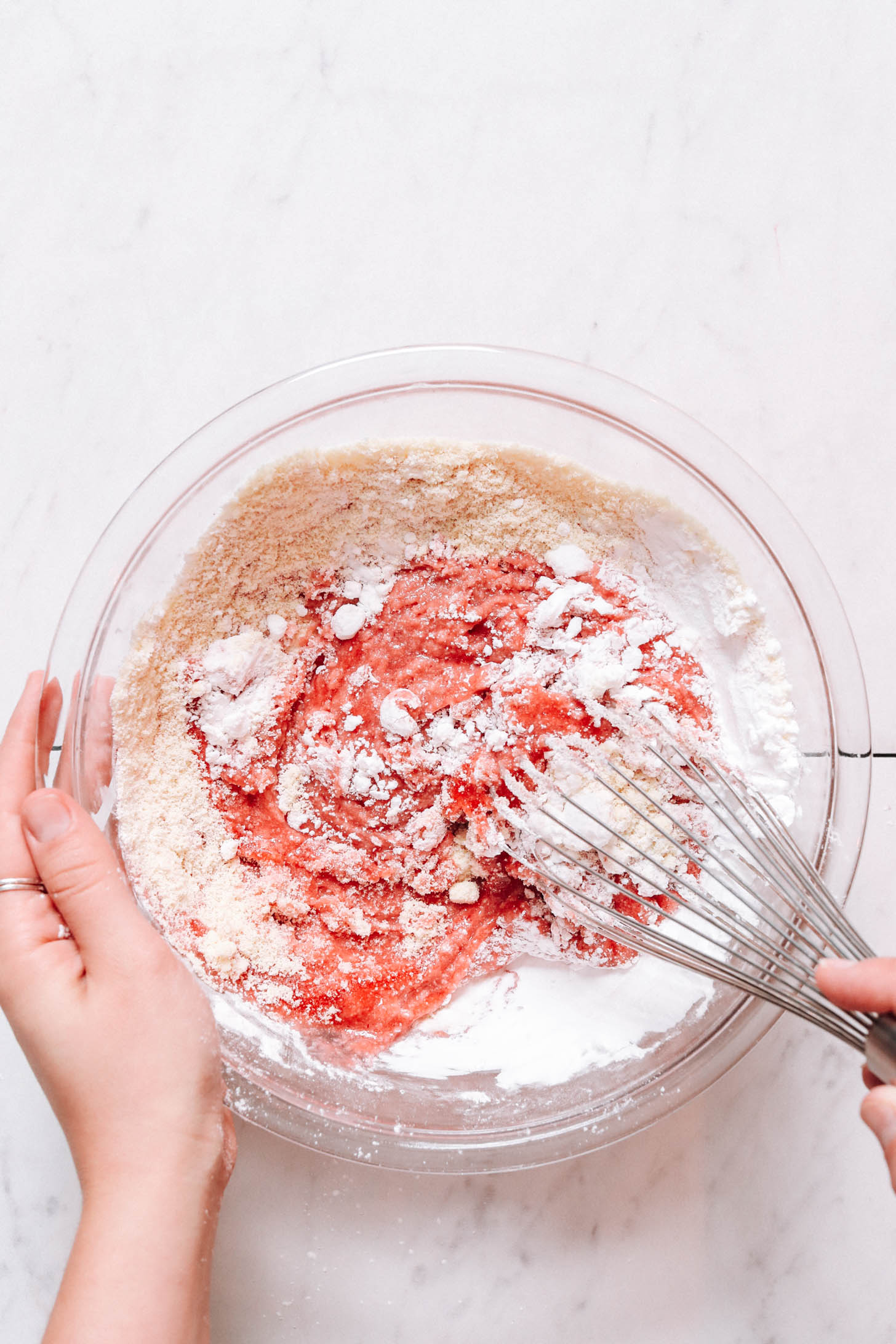 Using a whisk to mix wet and dry ingredients