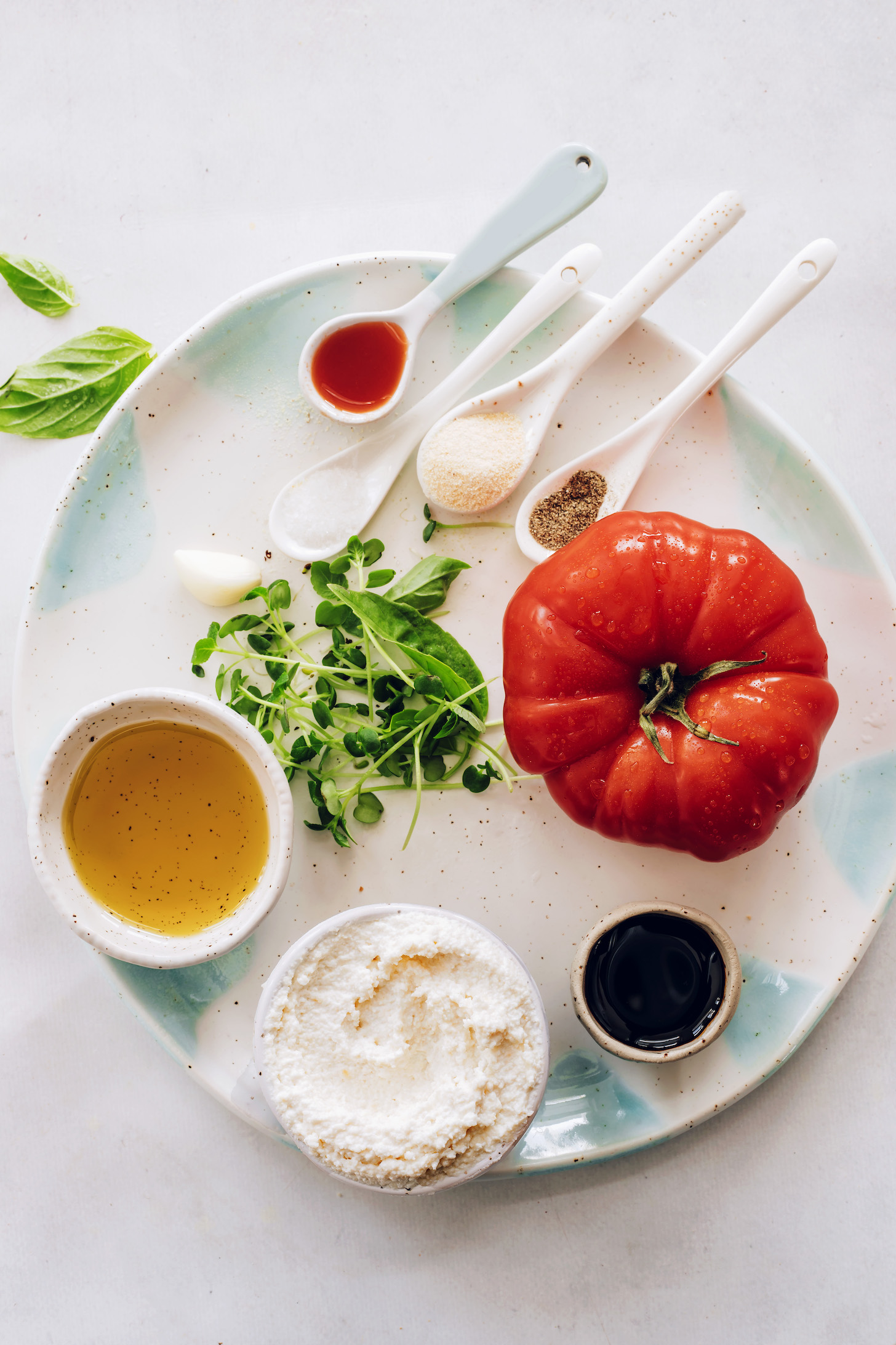 Olive oil, cashew ricotta, balsamic vinegar, tomato, basil, microgreens, black pepper, garlic powder, salt, garlic, and tomato juice