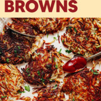 A spread of crispy hash browns with ketchup