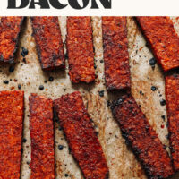 Slices of vegan bacon on a baking sheet with text above that says Easy Tempeh Bacon and just 8 ingredients