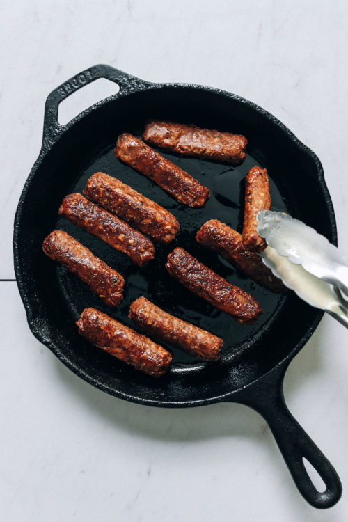 Cooking vegan sausage links in a cast iron skillet