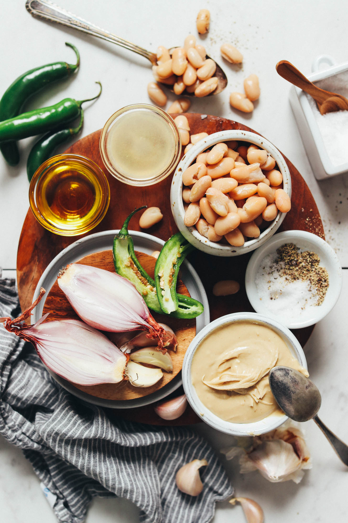Serrano peppers, white beans, lemon, olive oil, shallot, garlic, cashew butter, salt, and pepper