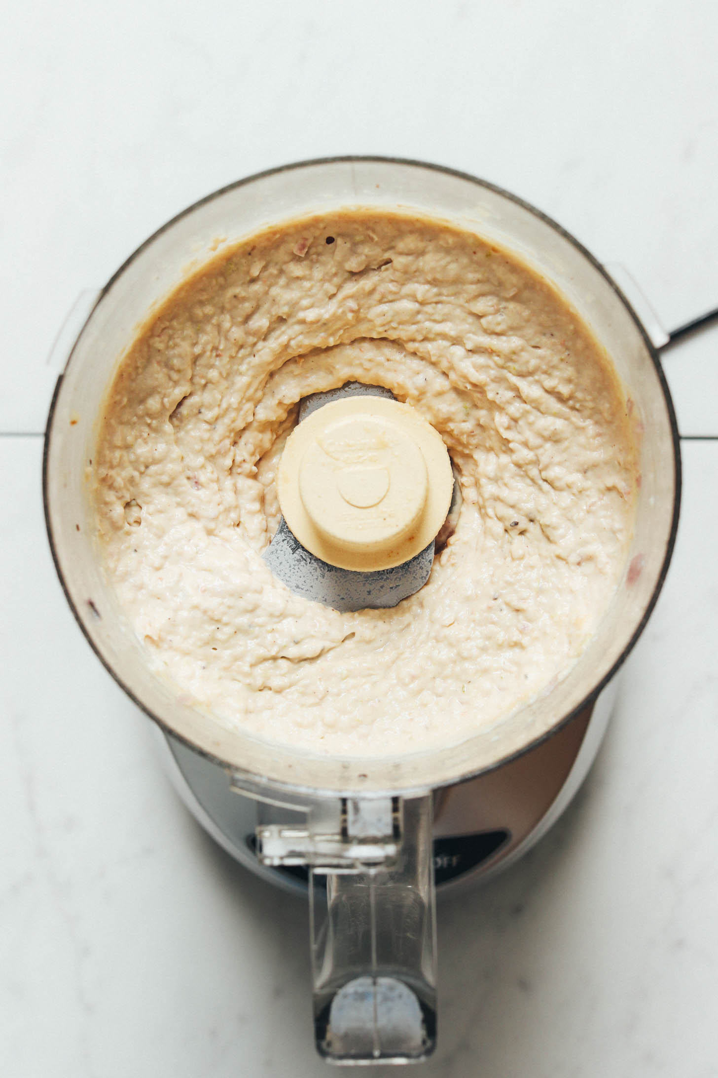Creamy vegan white bean dip in a food processor