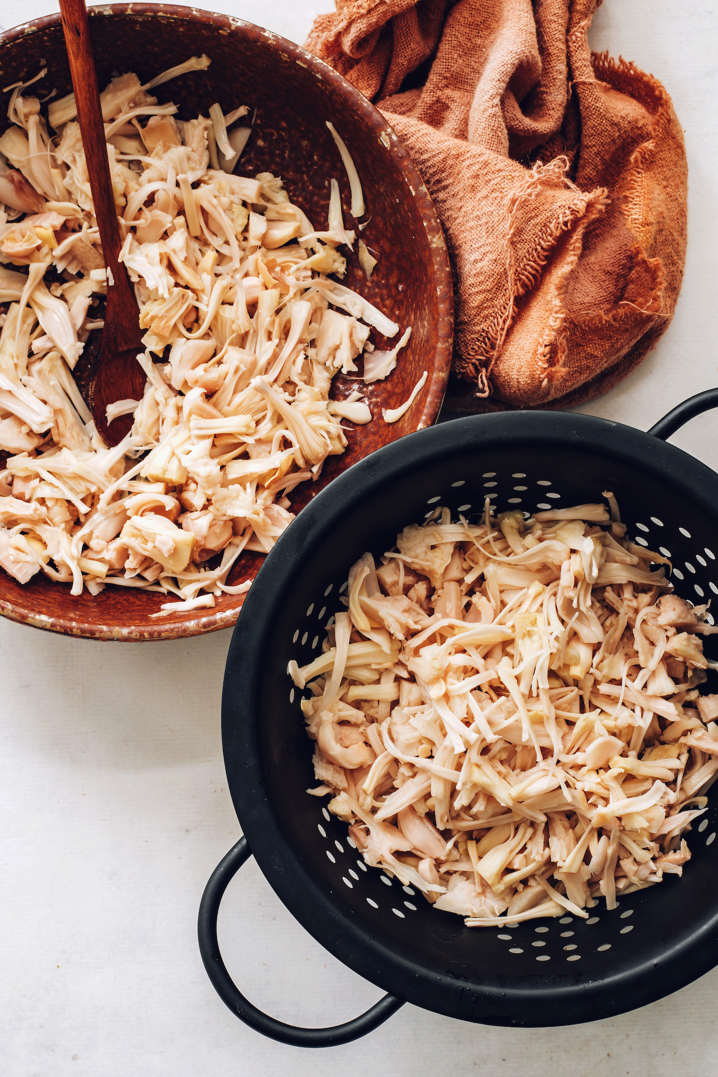 Bowl and colander of shredded young jackfruit