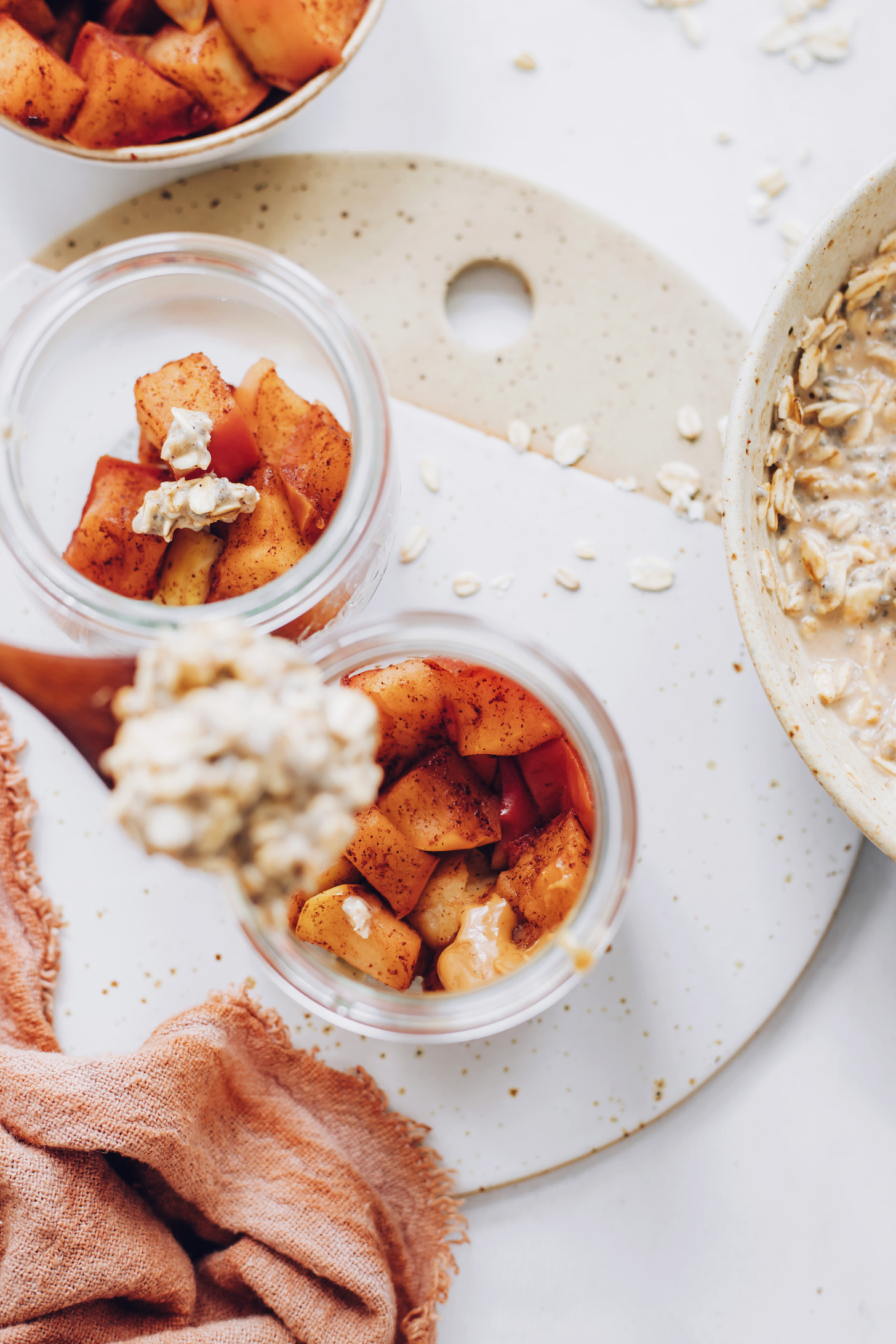 Scooping oat mixture over cooked apples