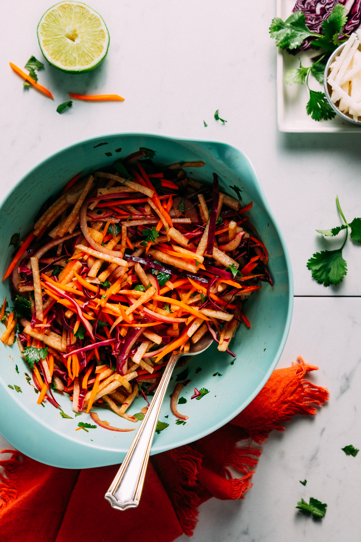 Vintage spoon in a bowl of our crunchy jicama slaw recipe