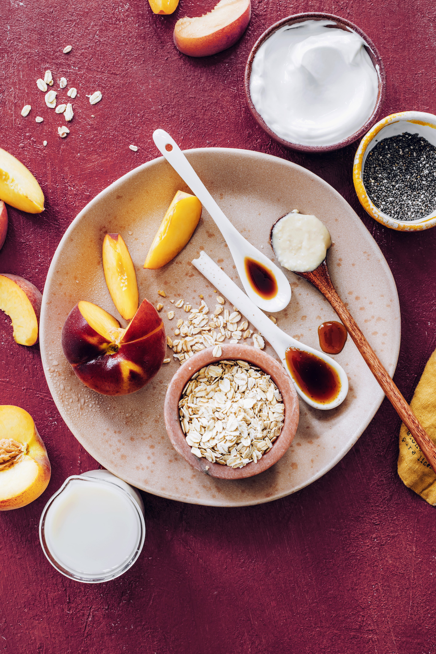 Coconut yogurt, chia seeds, coconut butter, vanilla, maple syrup, oats, almond milk, and peaches