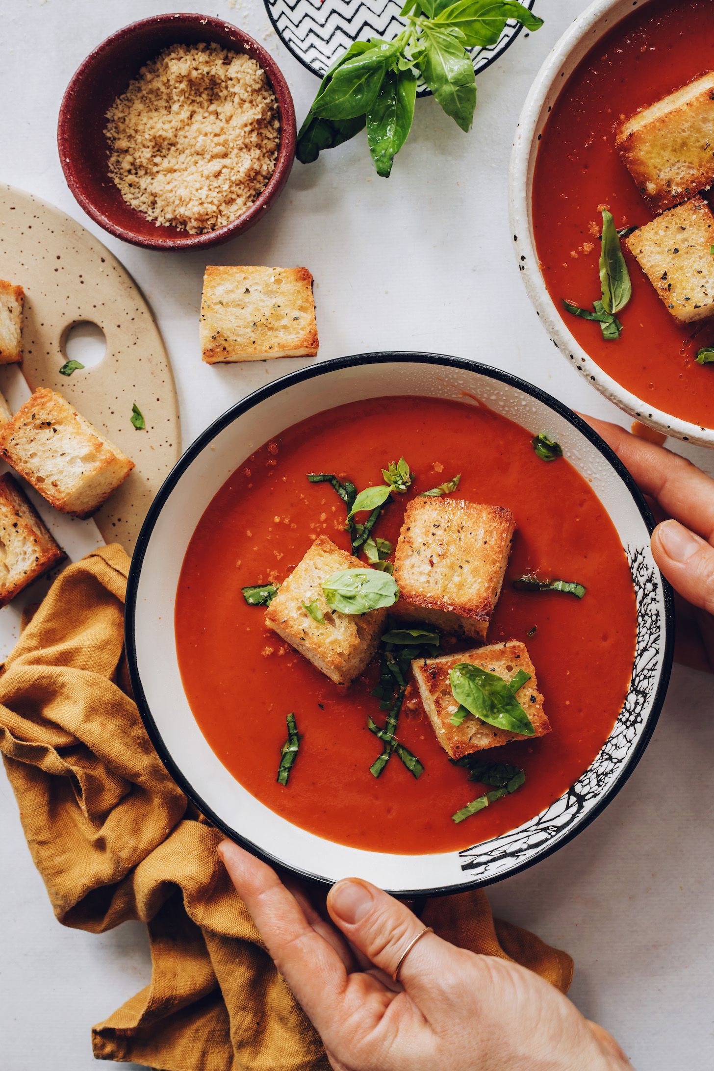 Holding the sides of a bowl of our easy vegan tomato soup