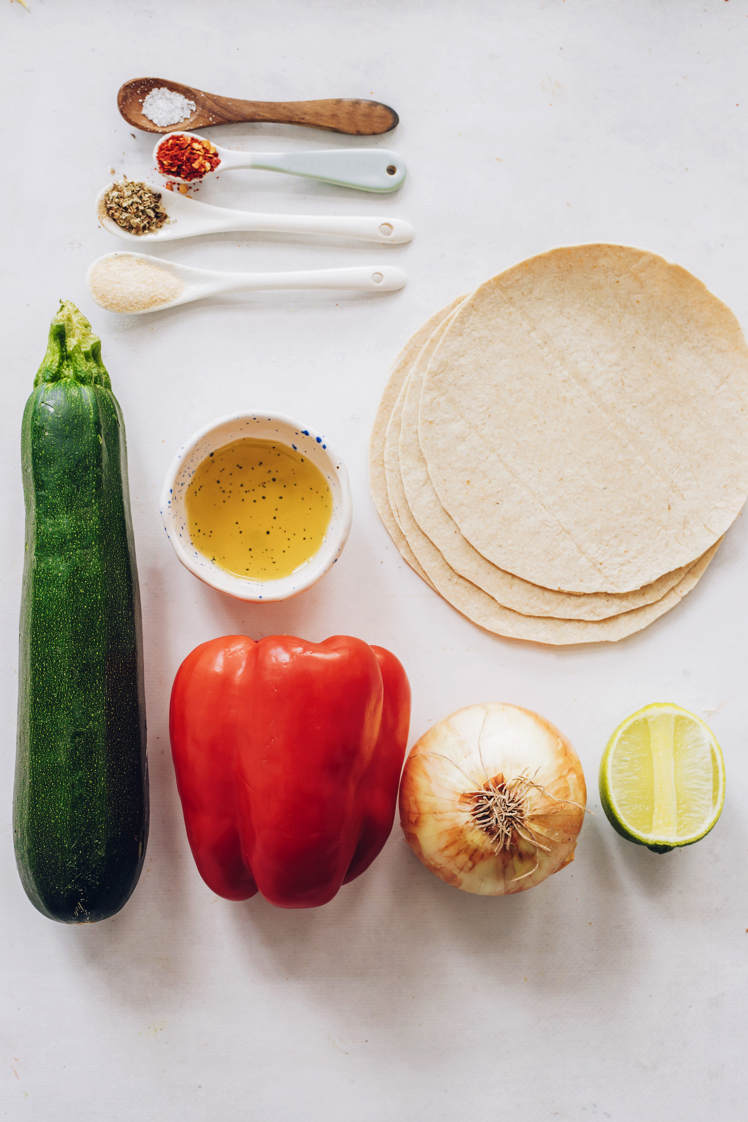 Zucchini, bell pepper, onion, lime, olive oil, corn tortillas, garlic powder, salt, and oregano