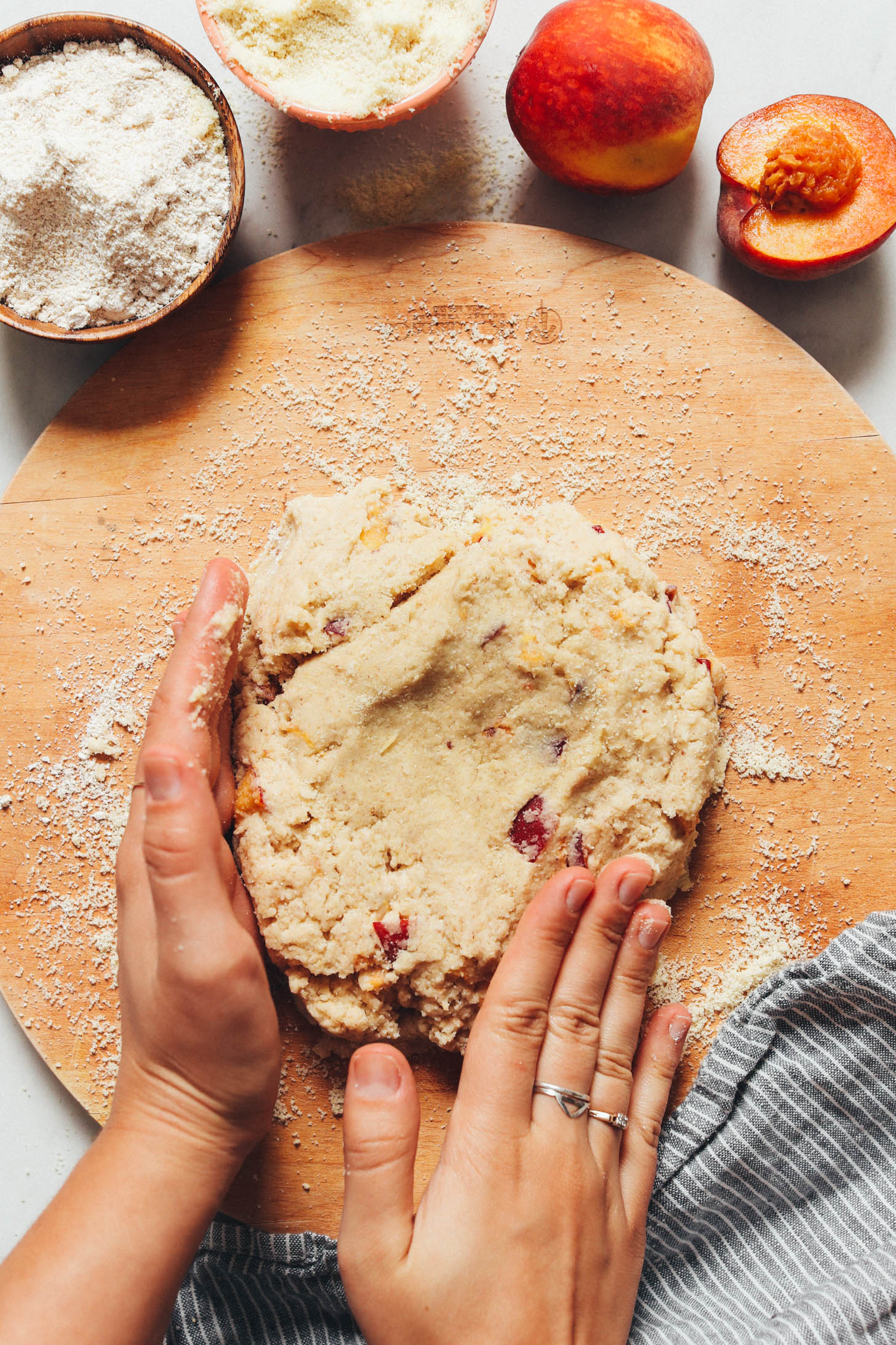 Shaping peach scone dough on a wood cutting board