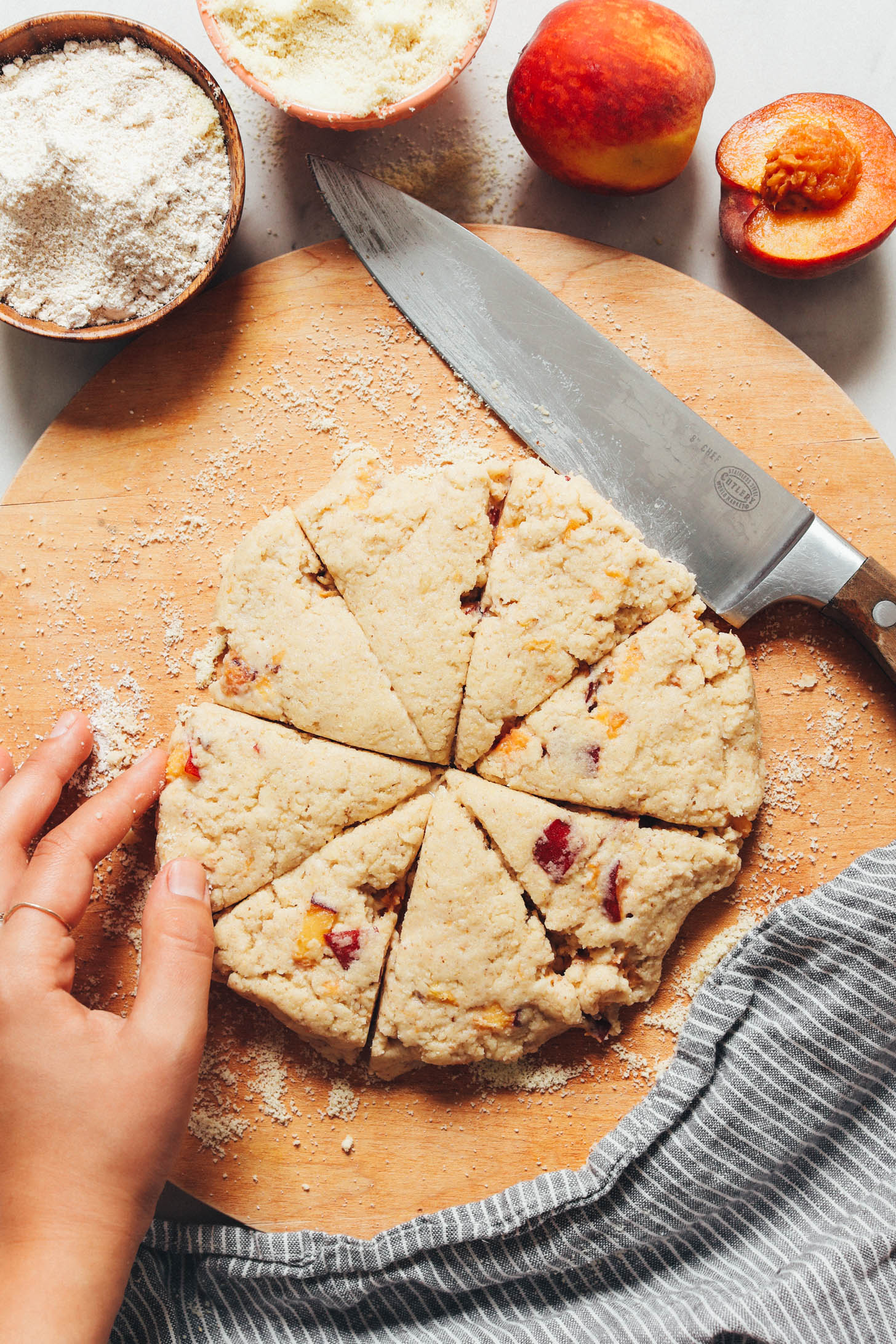 Peach scone dough on a floured wood cutting board