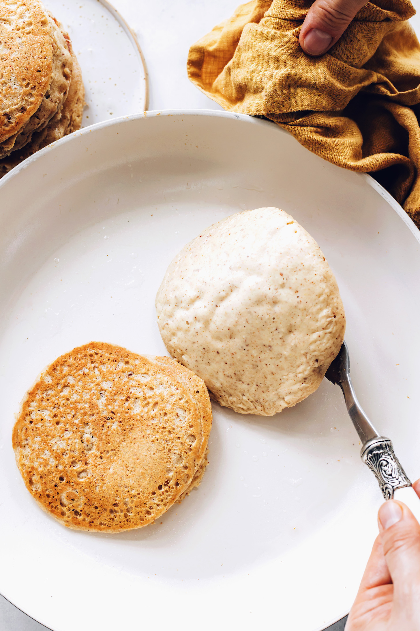 Flipping gluten-free pancakes in a skillet