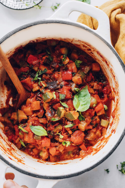 Pot of our easy ratatouille recipe topped with fresh basil