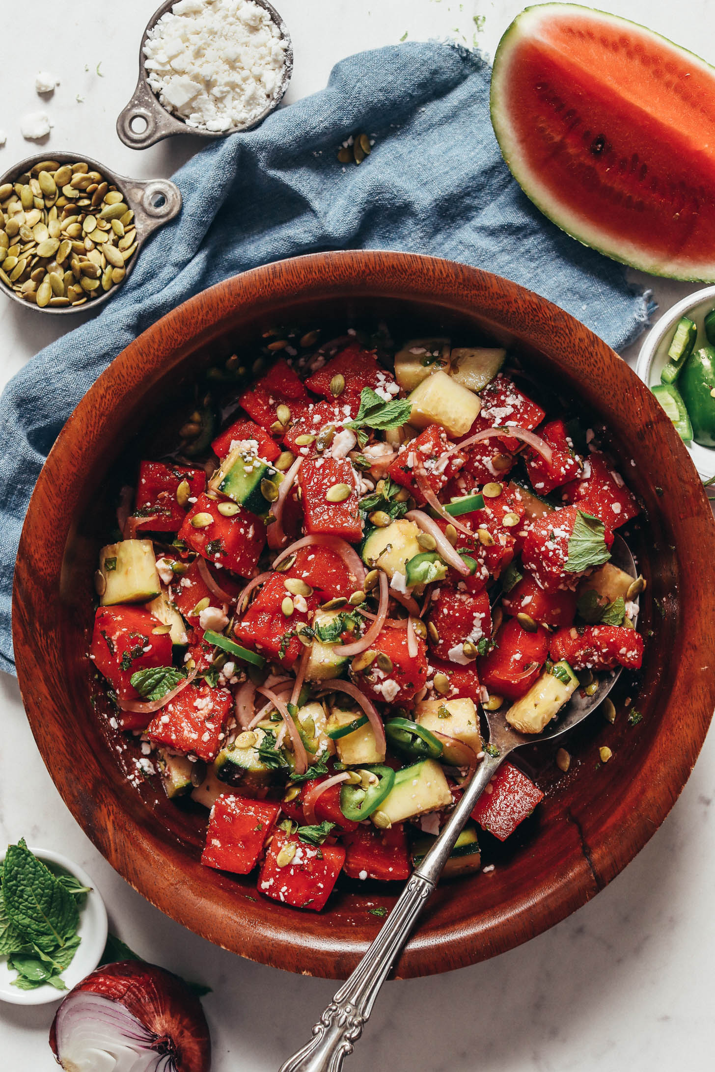 Bowl of minty watermelon cucumber salad with vegan feta