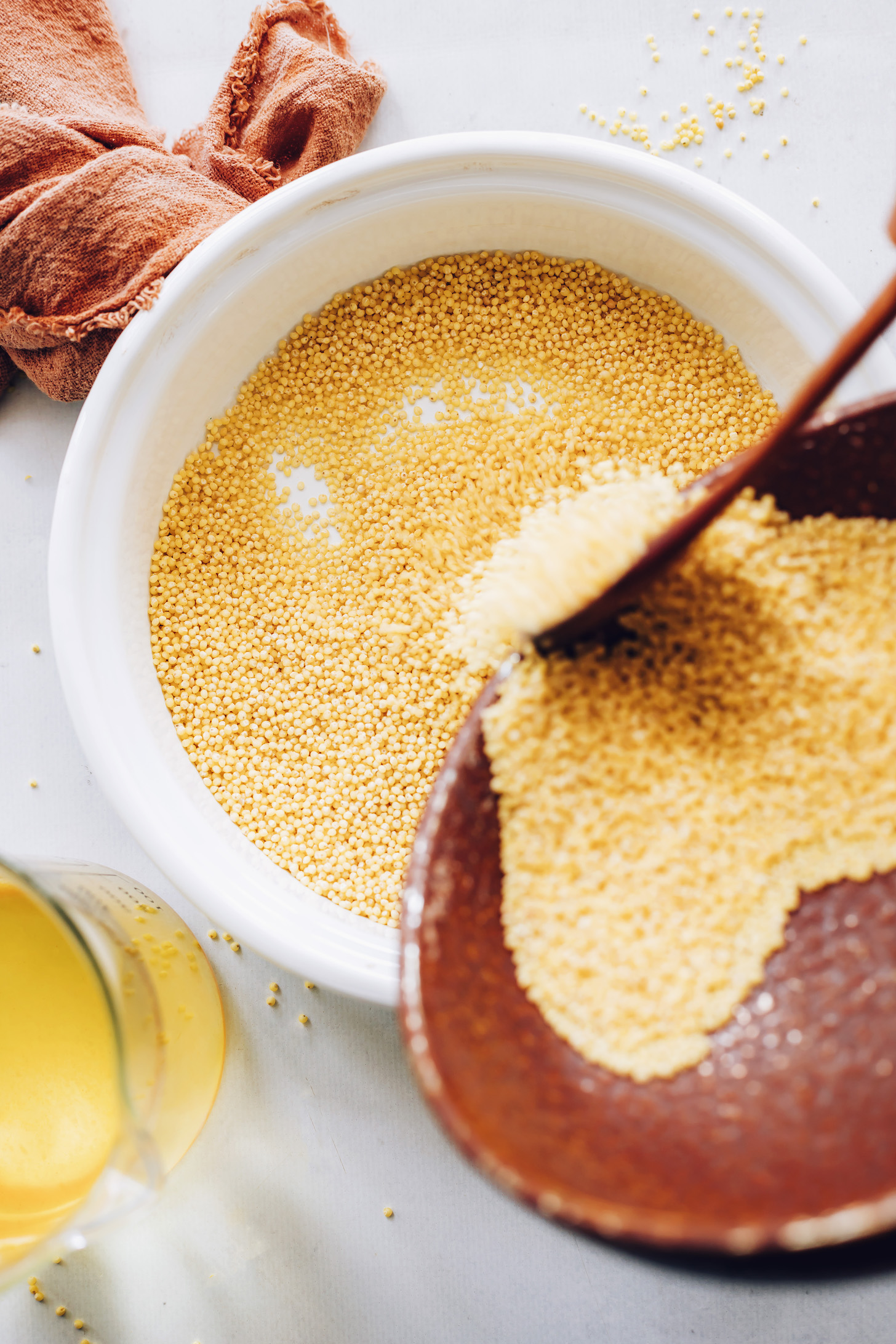 Adding millet to a saucepan
