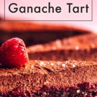 Slices of vegan and gluten-free raspberry chocolate ganache tart with a raspberry on top