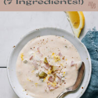 Dish of easy vegan tartar sauce with lemon wedges on the side