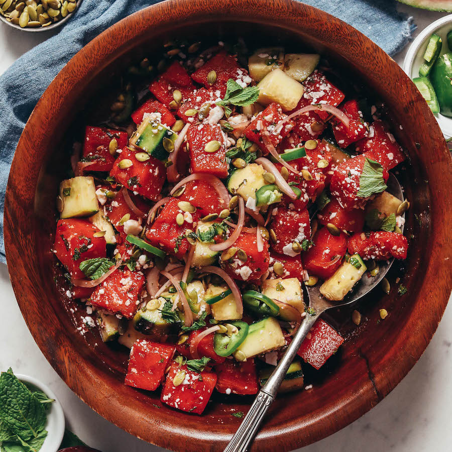 Wood bowl filled with cucumber watermelon salad