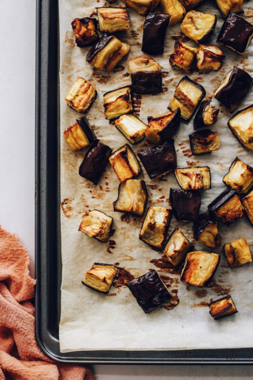 Baking sheet of perfectly tender oven roasted eggplant cubes