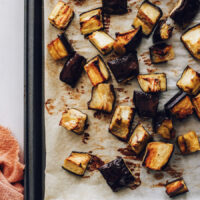 Cubed roasted eggplant on a baking sheet