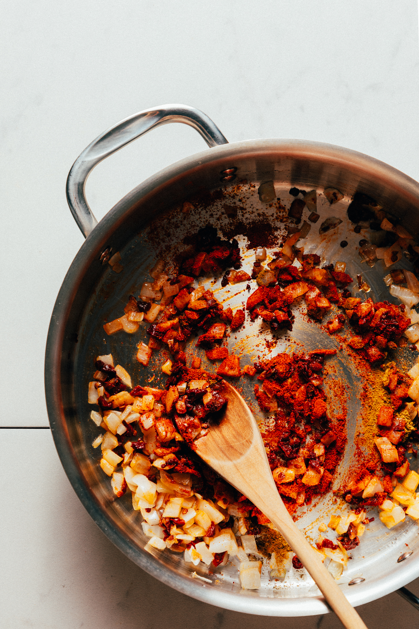 Sautéing onions and spices in a skillet