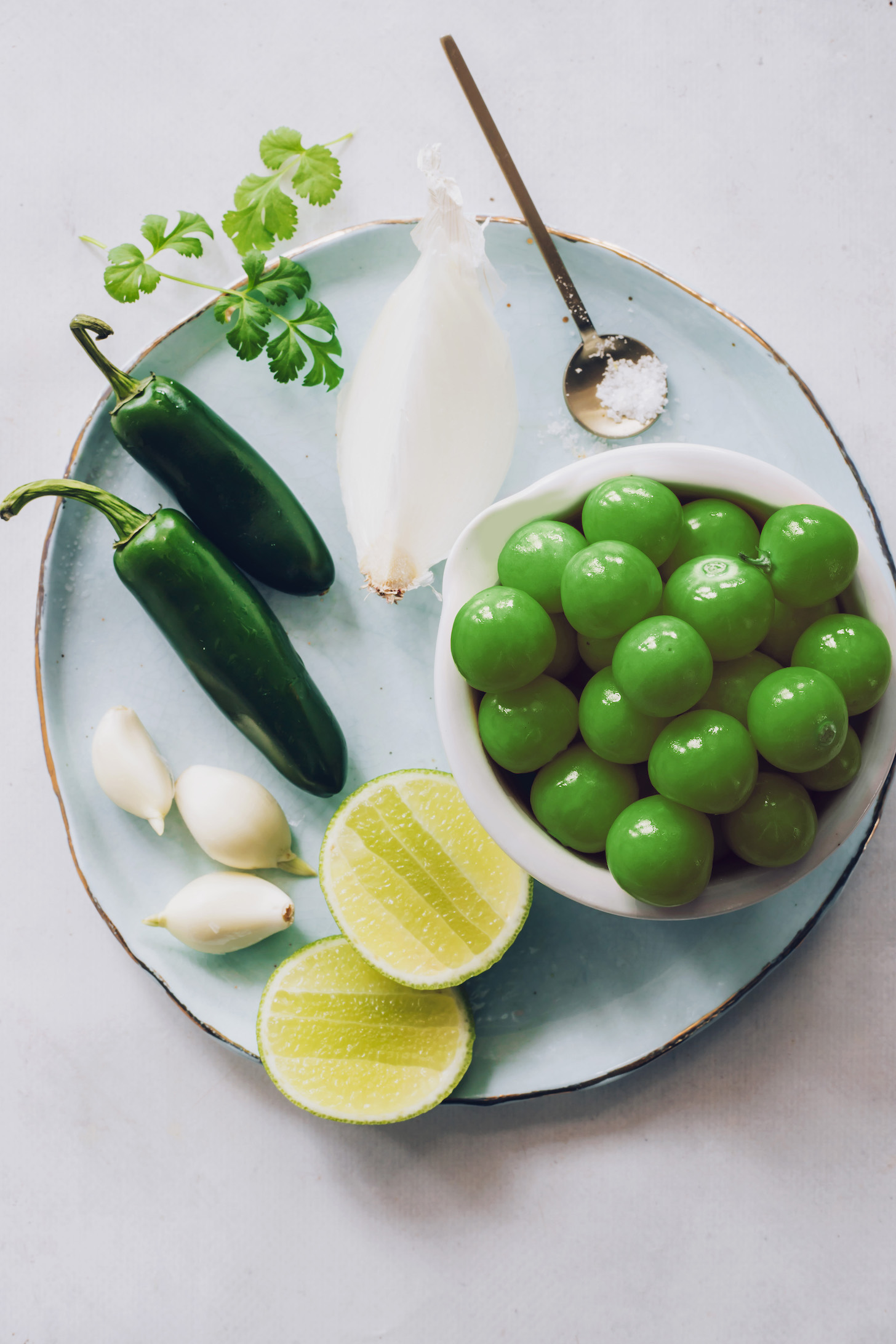 Tomatillos, onion, salt, limes, garlic, jalapeño, and cilantro