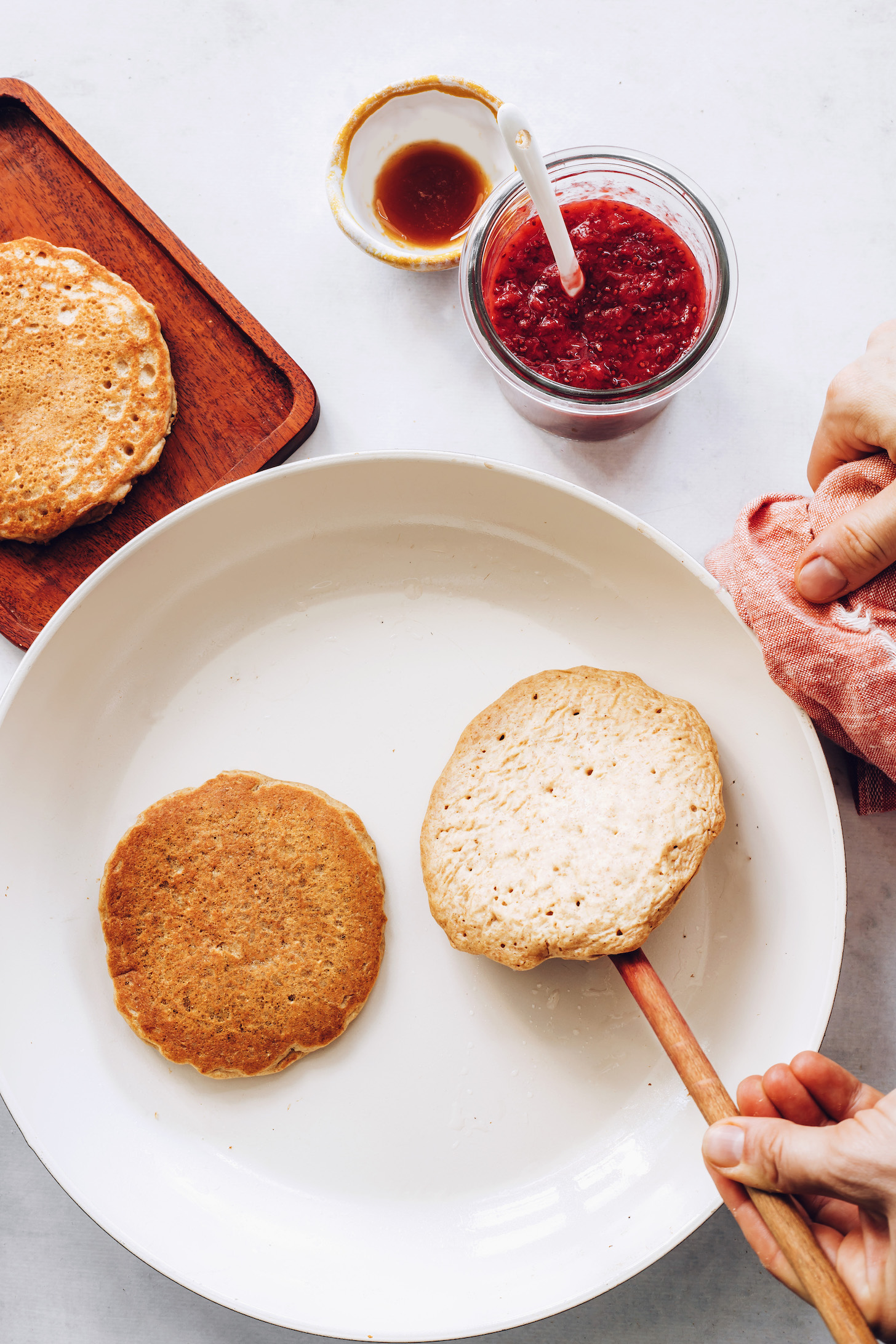 Cooking vegan whole grain pancakes in a skillet