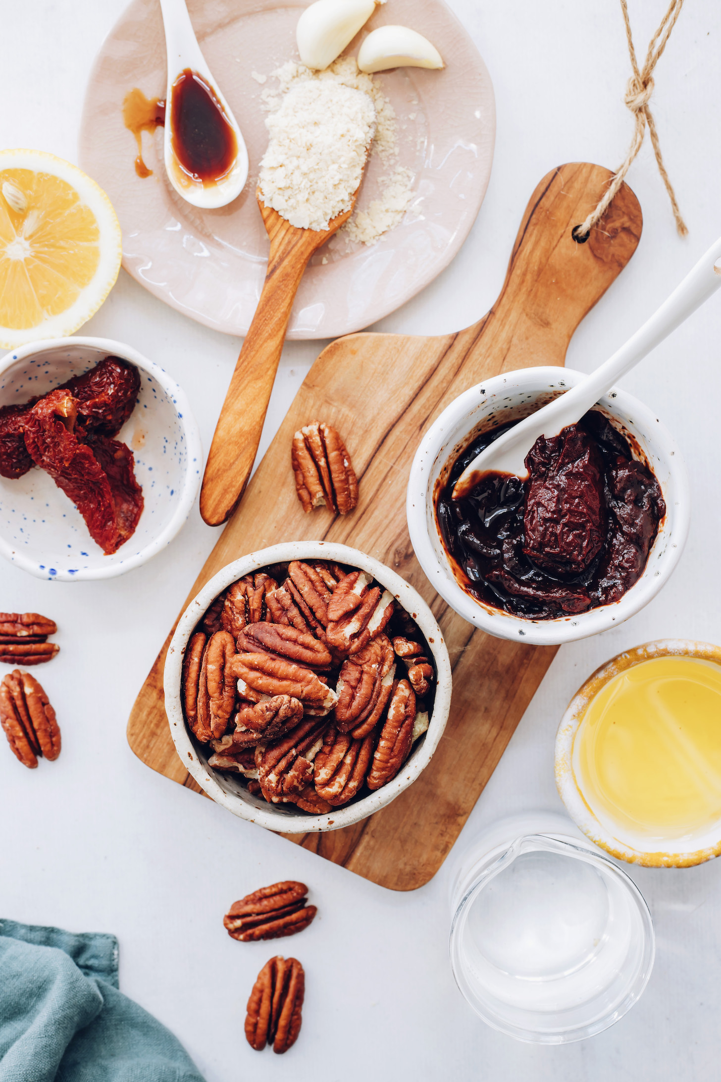 Garlic cloves, nutritional yeast, maple syrup, lemon, sun-dried tomatoes, pecans, chipotle peppers in adobo, olive oil, and water