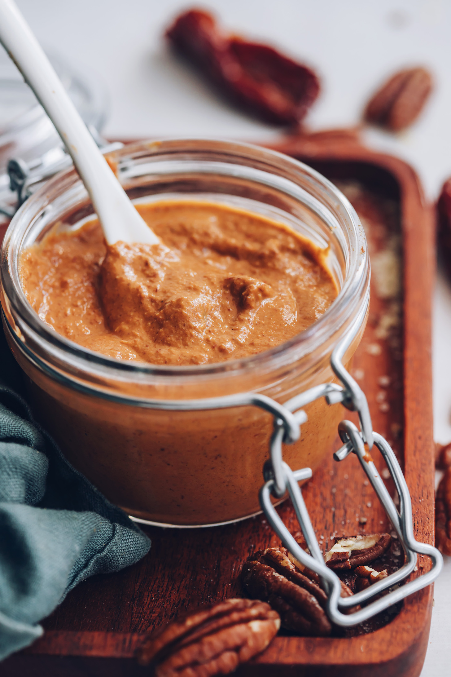 Spoon in a jar of chipotle pecan pesto