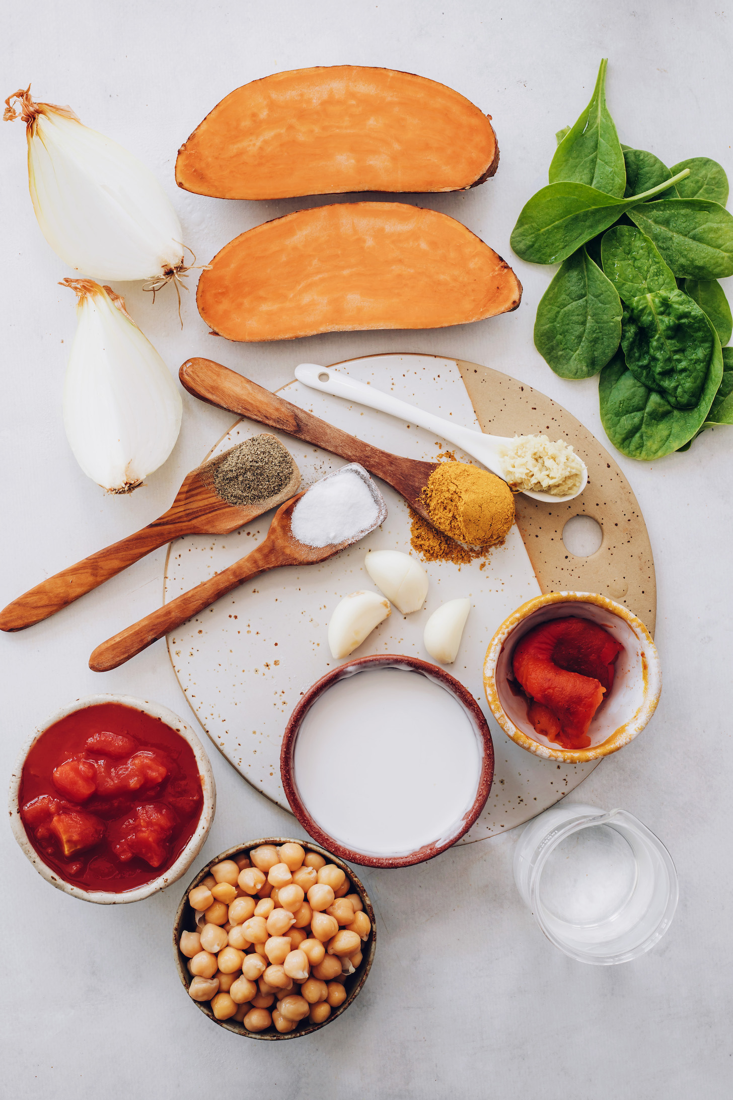 Onion, sweet potato, spinach, ginger, curry powder, garlic, salt, pepper, coconut milk, roasted red peppers, water, chickpeas, and tomatoes