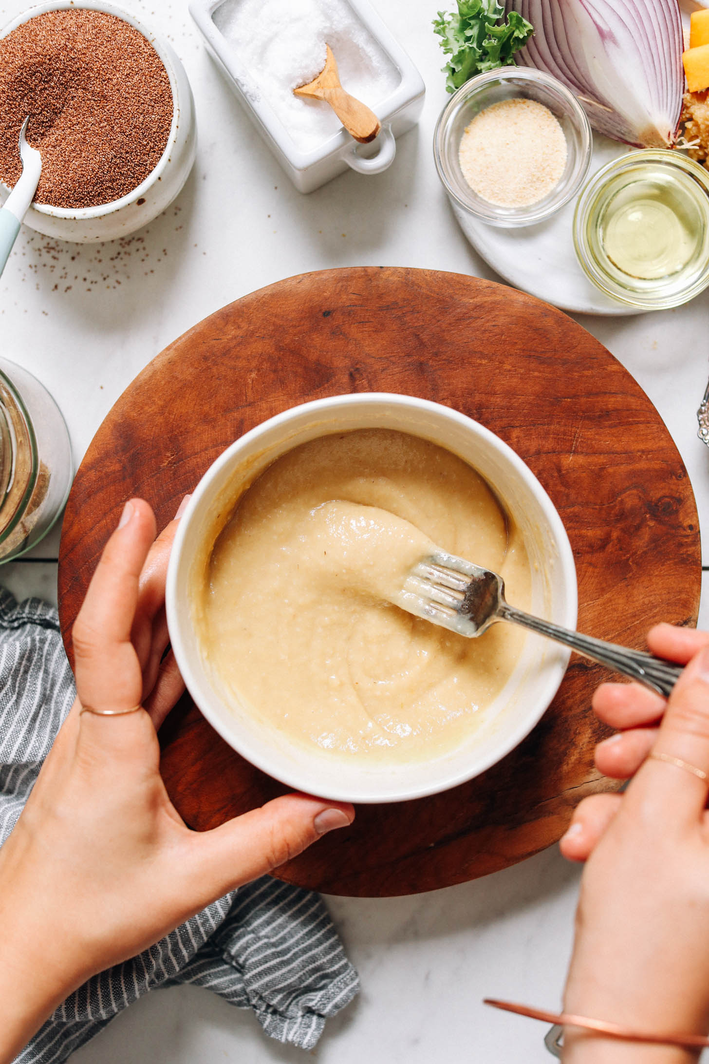 Stirring miso, avocado oil, and water in a bowl