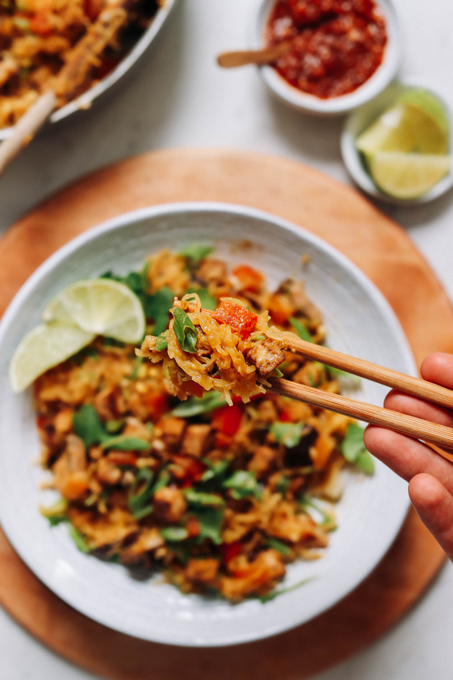 Chopsticks holding a bite of spaghetti squash stir-fry