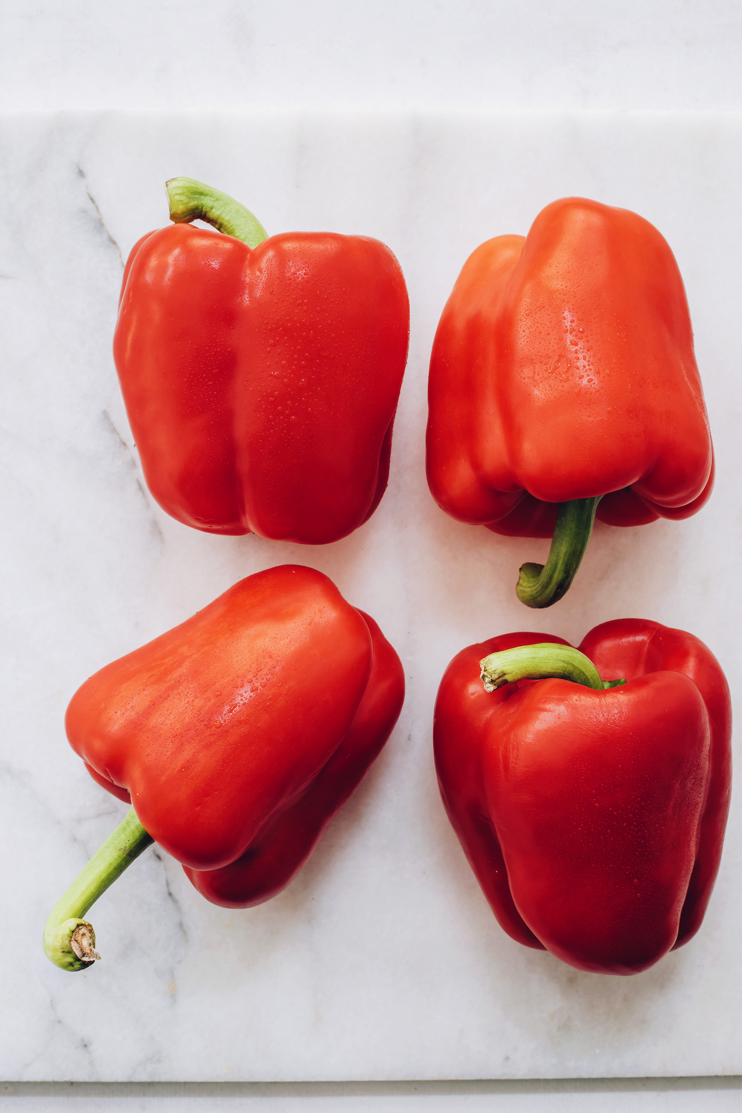 Four red bell peppers