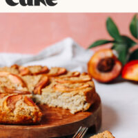 Slice of our fluffy millet breakfast cake next to the rest of the cake