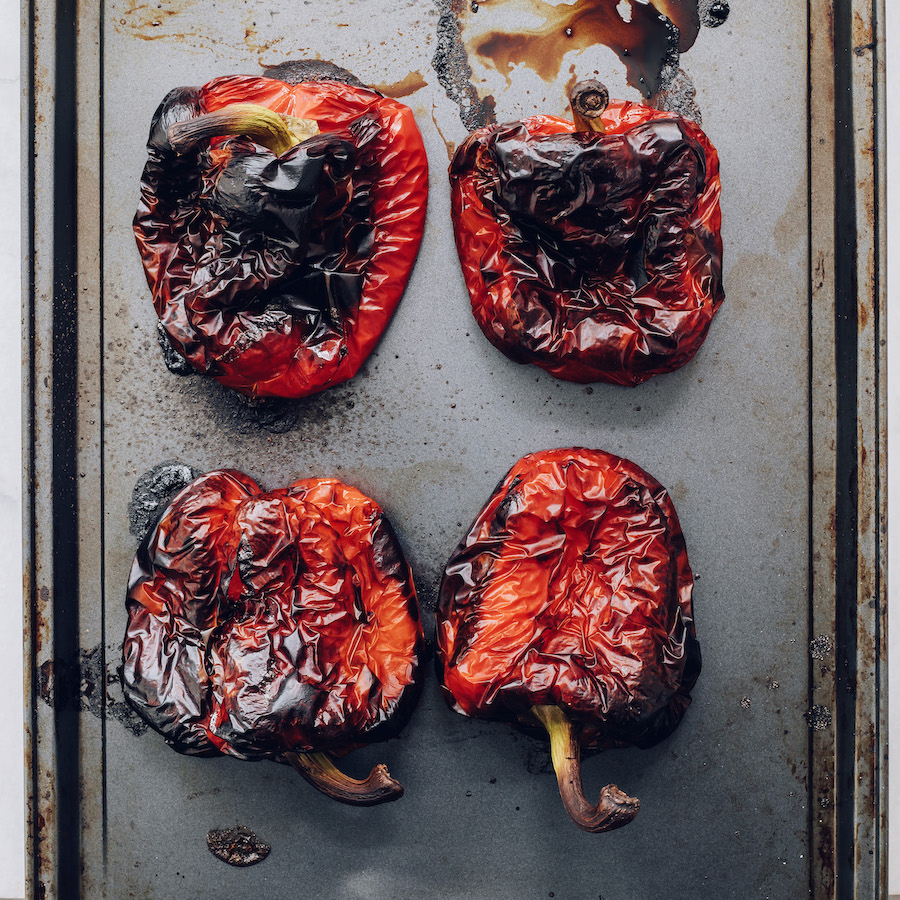 Roasted red peppers on a baking sheet