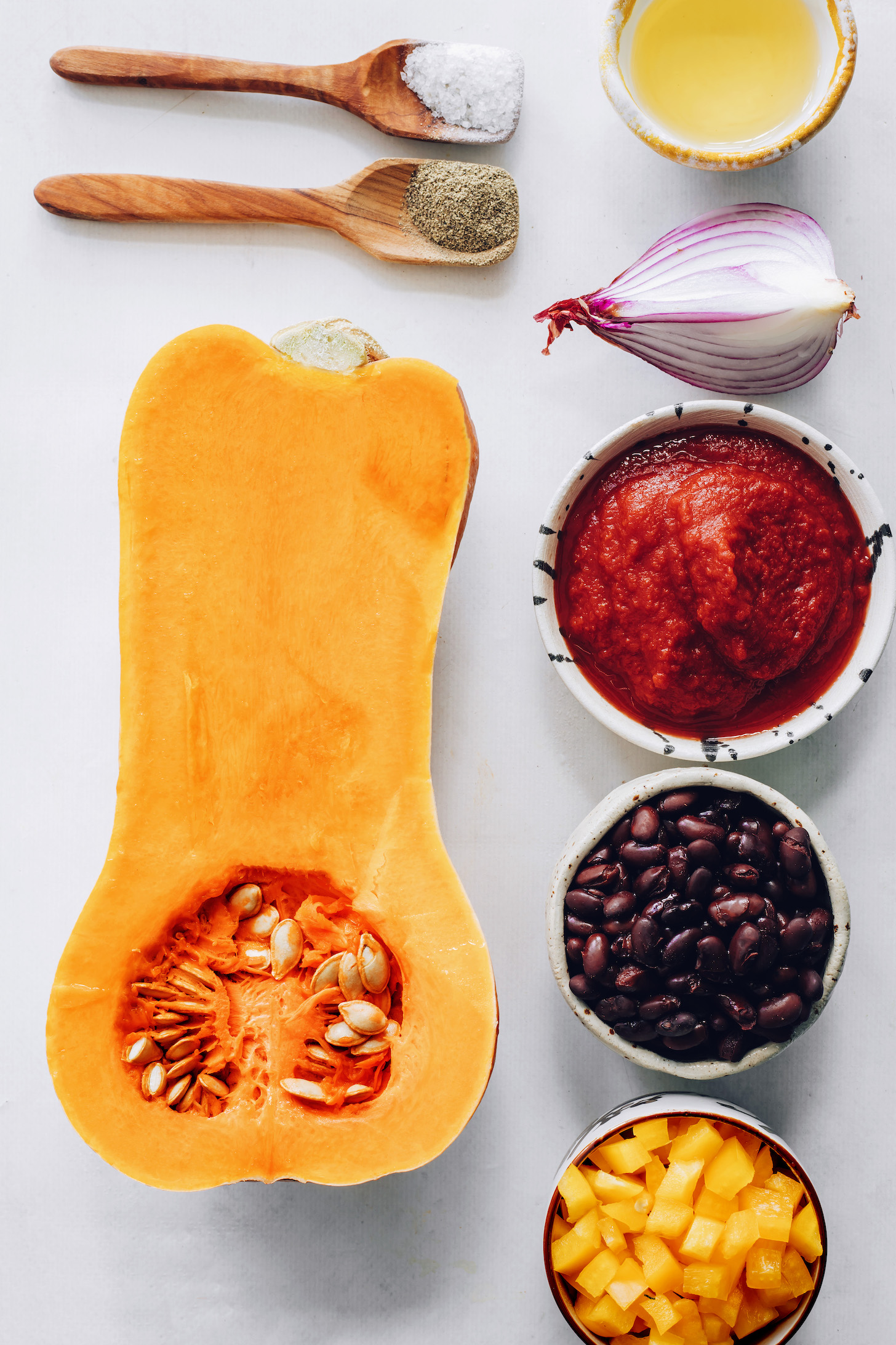 Salt, pepper, butternut squash, bell pepper, black beans, enchilada sauce, red onion, and oil