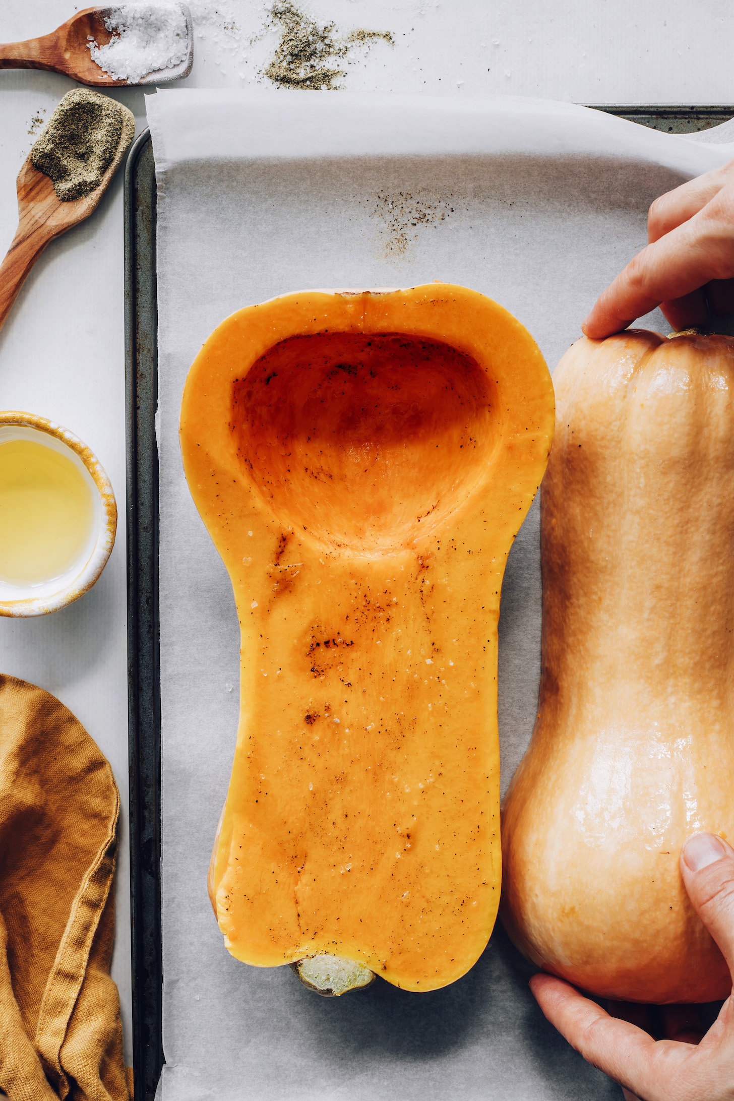 Halved butternut squash rubbed with oil, salt, and pepper