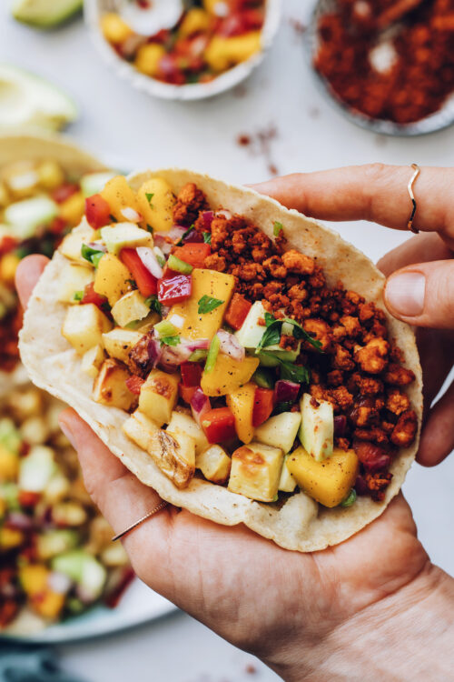 Holding a vegan chorizo breakfast taco