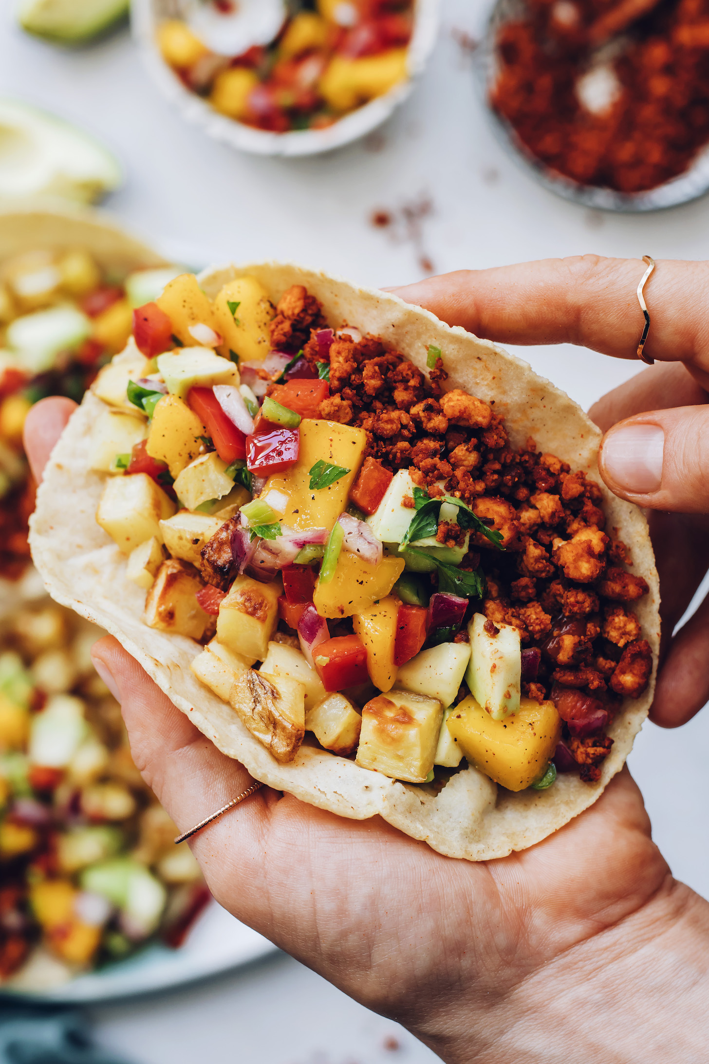Holding a vegan chorizo taco
