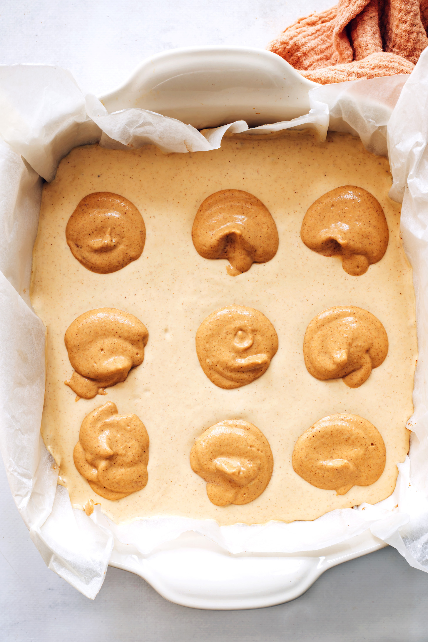 Dollops of darker pumpkin filling on a lighter filling as the base