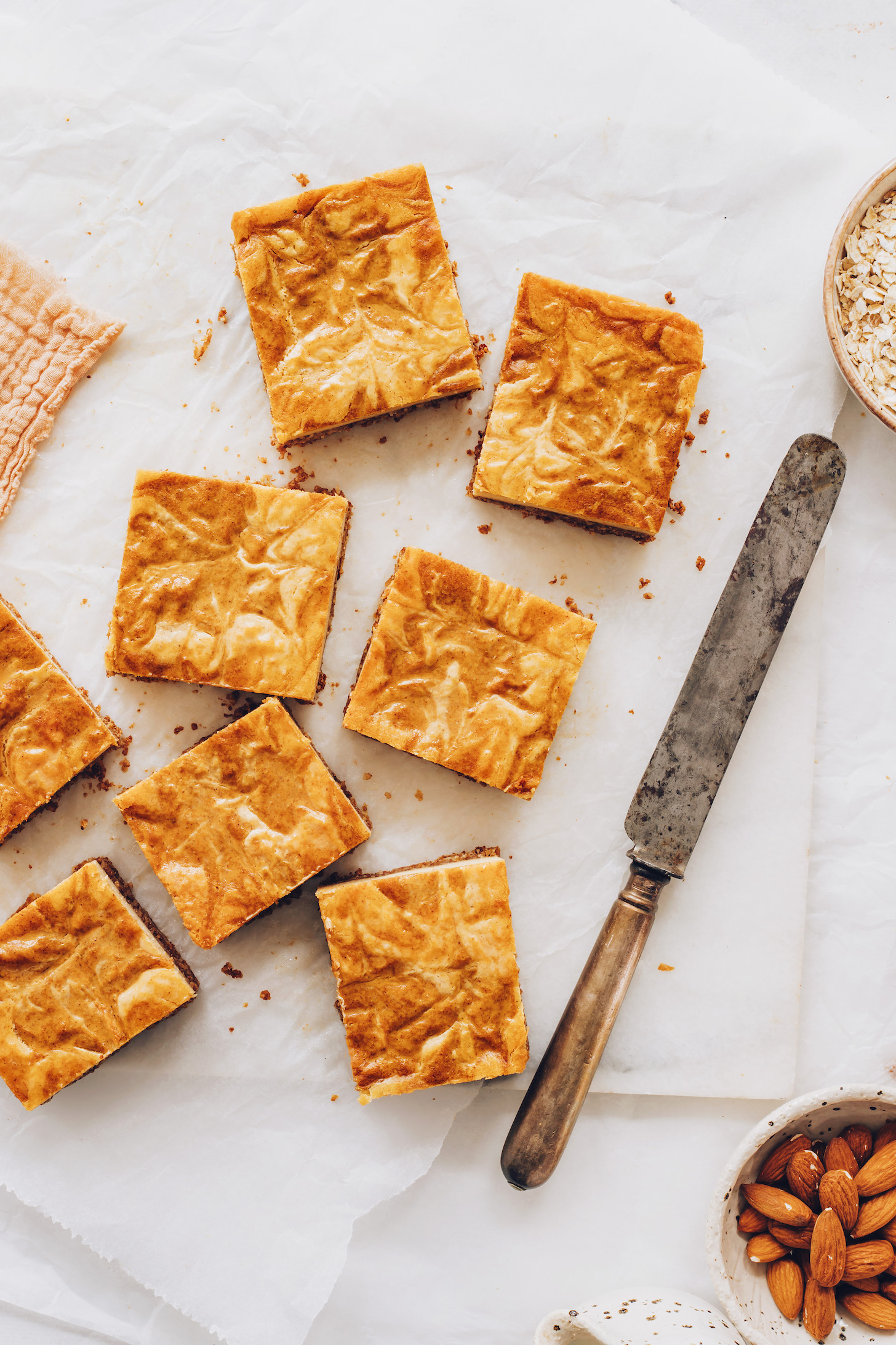 Knife resting beside pumpkin cheesecake bars
