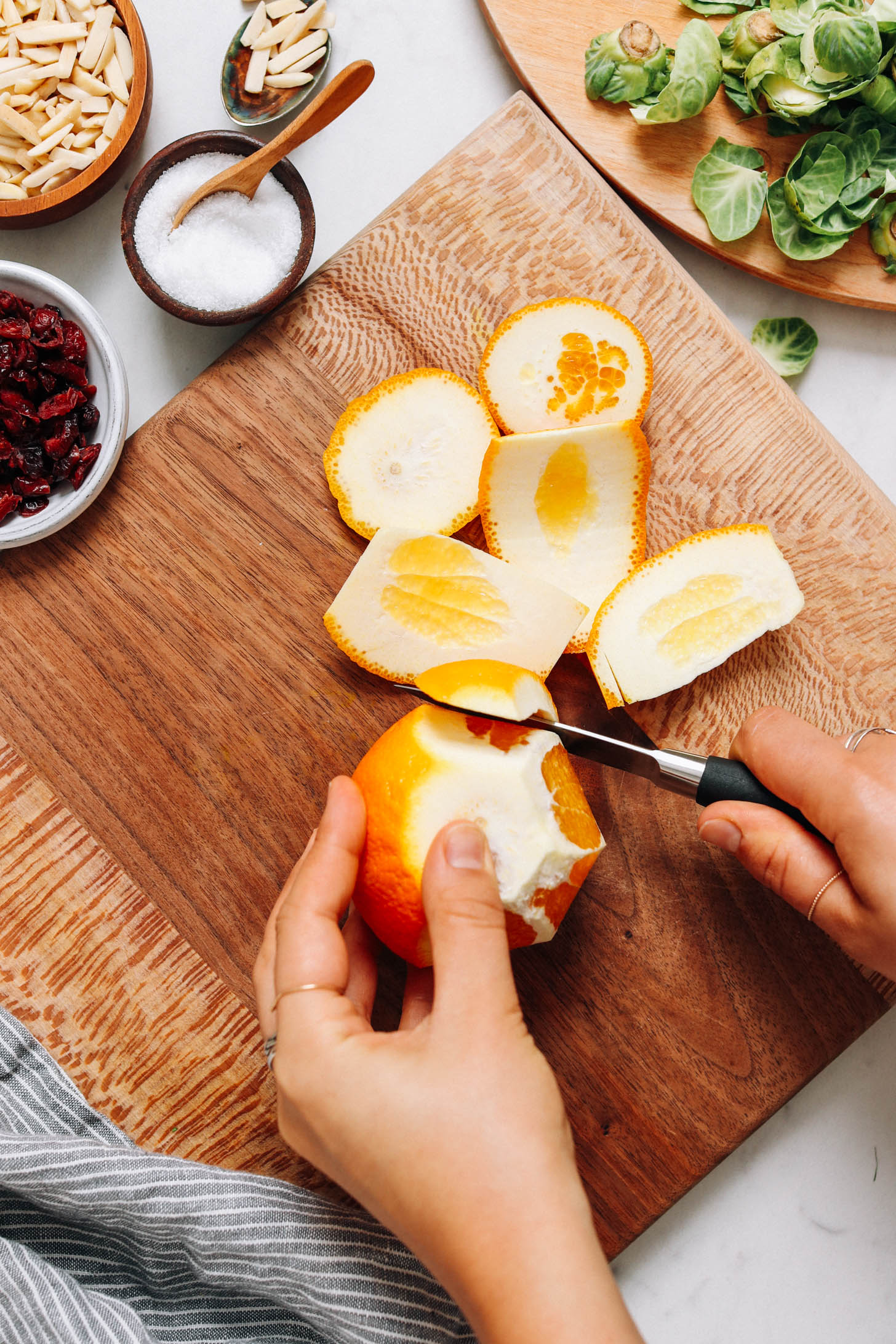 Cutting the peel off an orange