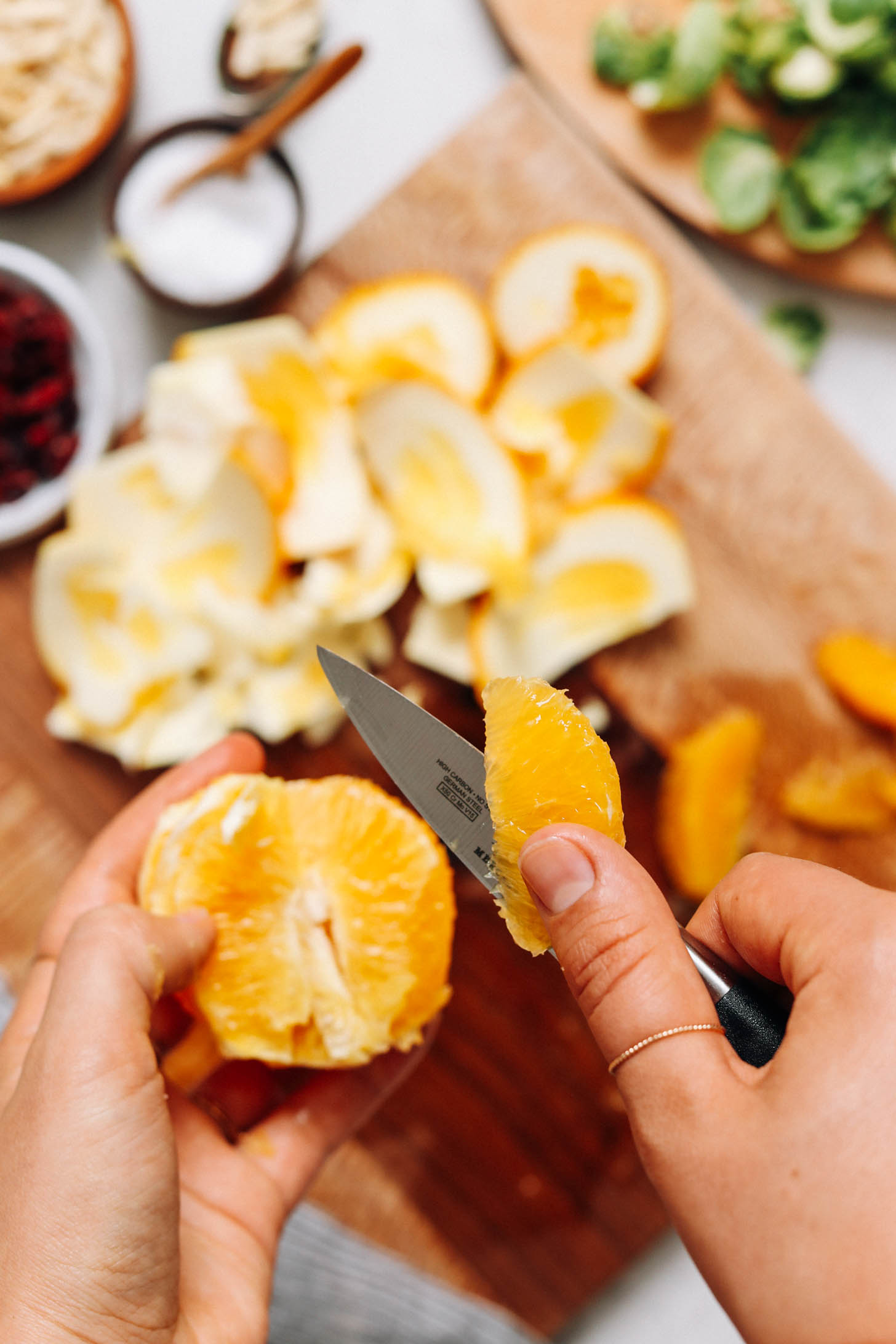 Using a small knife to supreme an orange