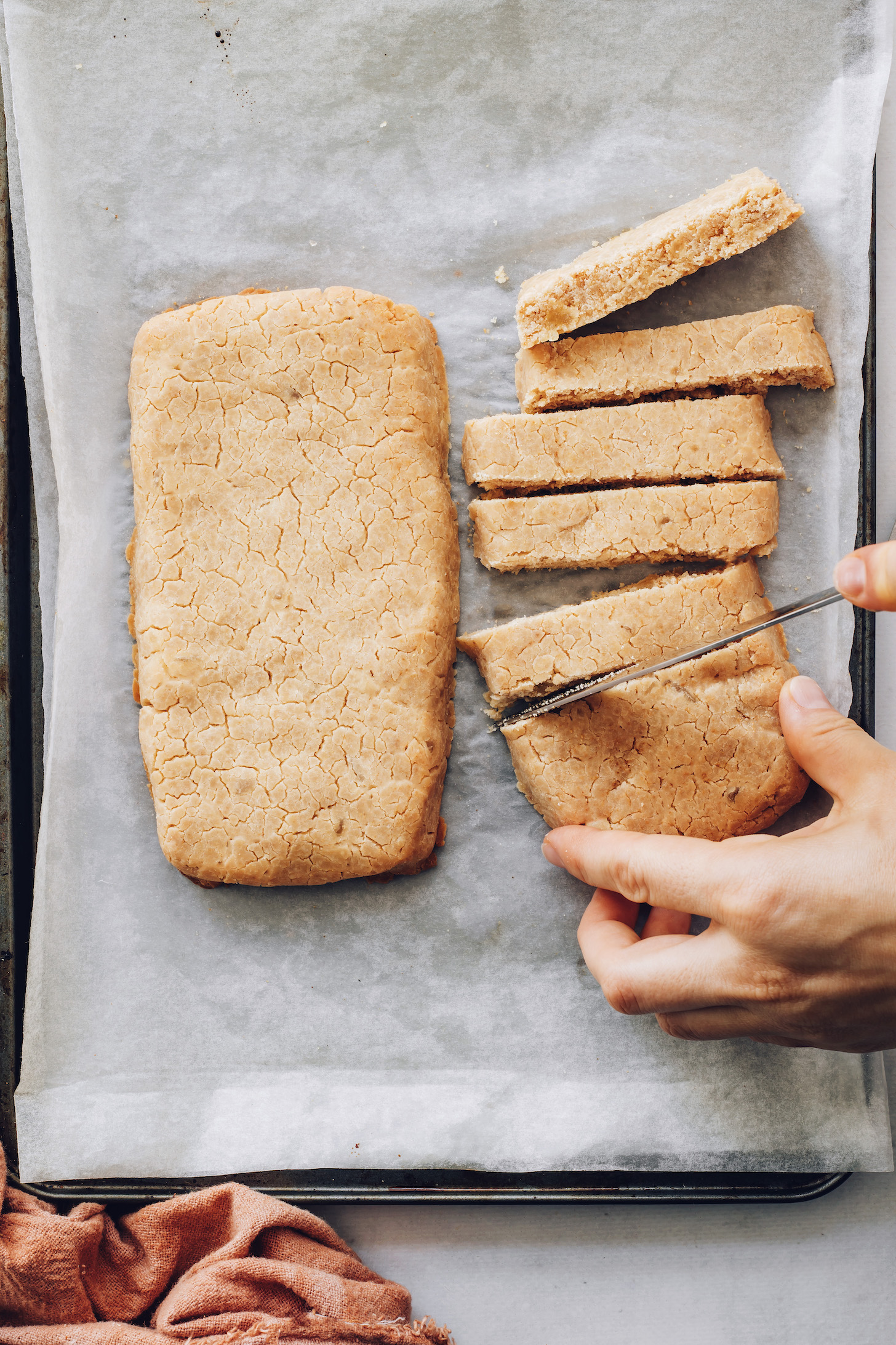 Slicing logs of gluten-free biscotti