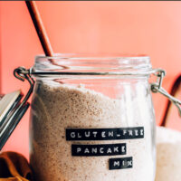 Jar of vegan and gluten-free pancake mix with a spoon in it