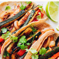 Plate of vegan and gluten-free bell pepper and zucchini tacos