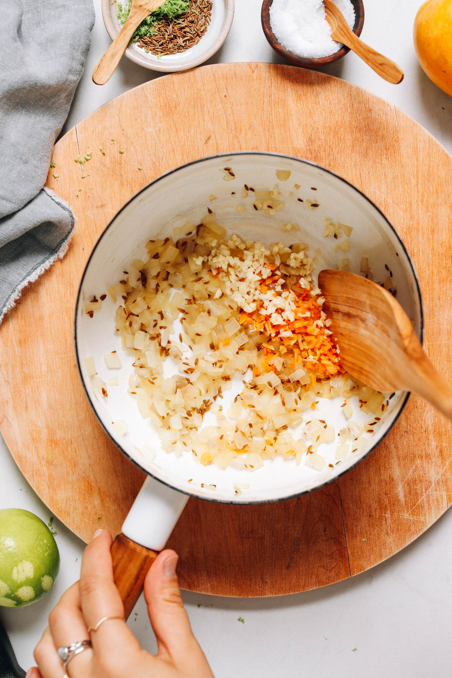 Sautéing onion, cumin seeds, habanero, and garlic in a saucepan